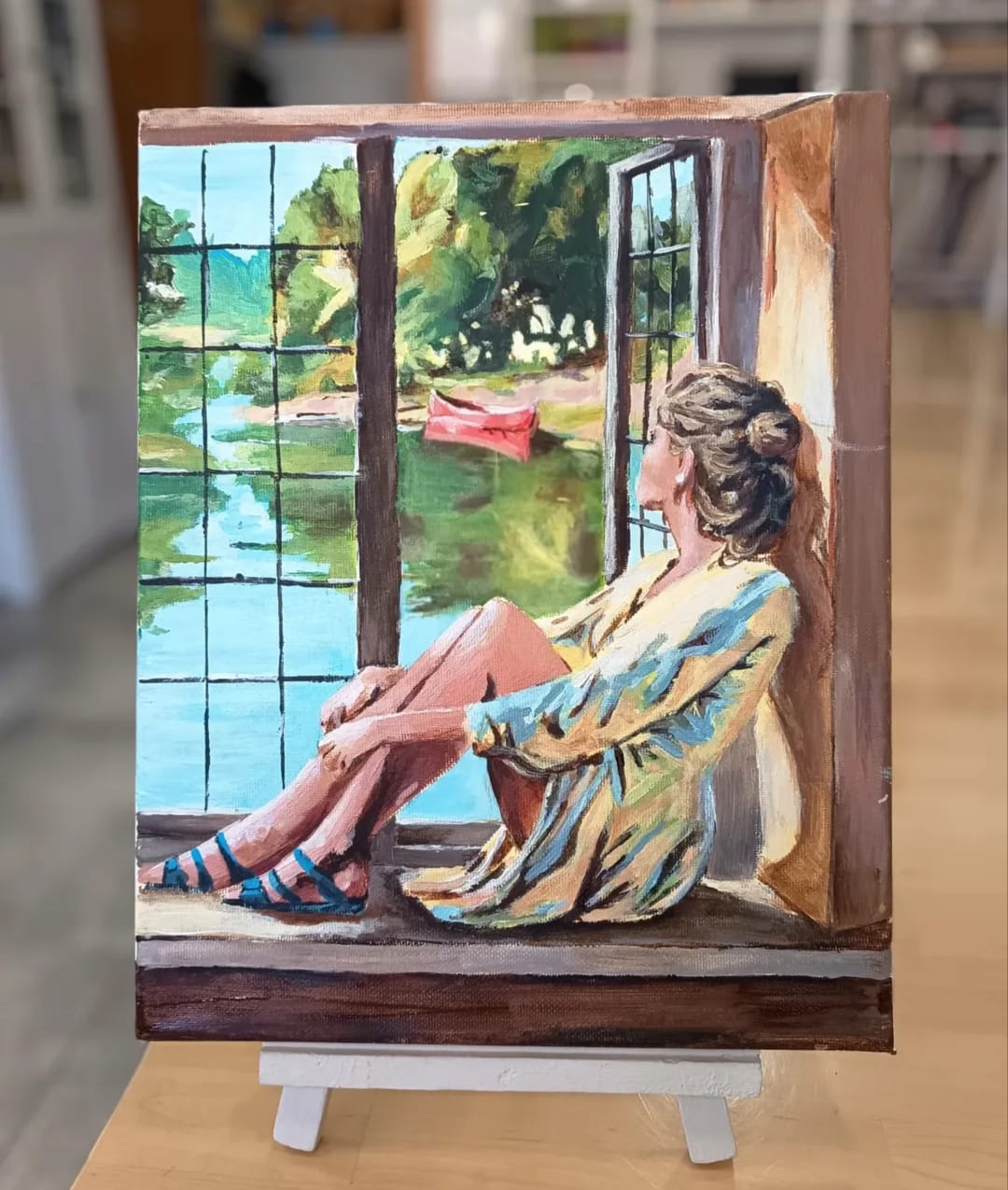 Pintura al óleo de mujer en ventana leyendo